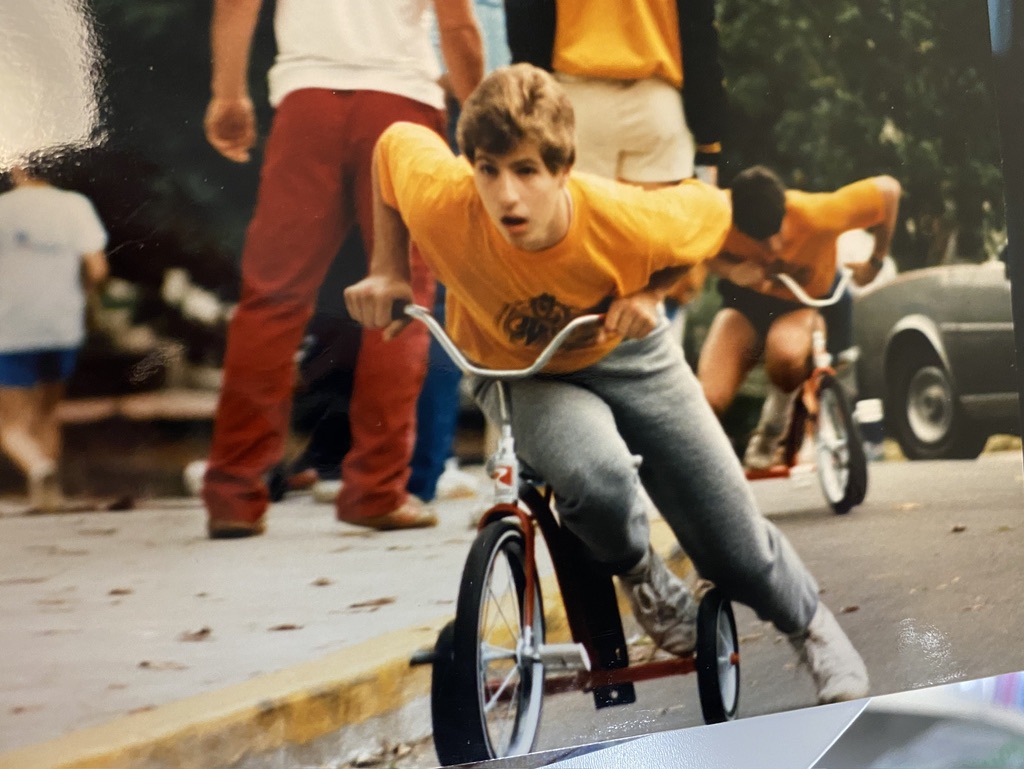 Randy in 1985, knees high on a child's tricycle in the Georgia Tech homecoming tricycle race
